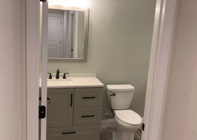 Lime bath after with designer vanity, mirror and light